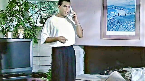 Handsome Latino man in casual shirt and pants on phone call