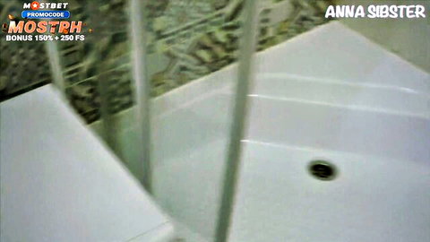 Empty tiled shower room with drain and Mostbet Anna Sibster watermarks overlaid