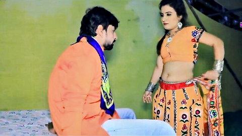 Desi Indian woman in orange lehenga seduced by bearded man on bed