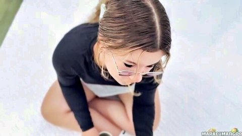 MaracuMangoo in glasses, wet hair, sitting in black top outdoors