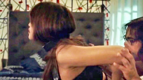 Brunette in black choker lingerie shows sideboob as man grabs her from behind in bedroom
