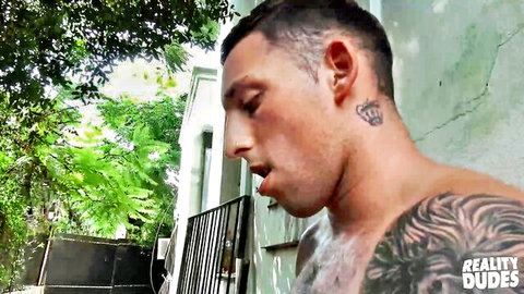Tattooed muscular twink shirtless outdoors at Love Trans Sex scene