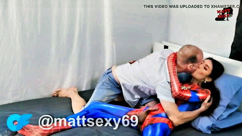 Oriental trans spidergirl in blue cosplay suit kisses bald white stud on bed