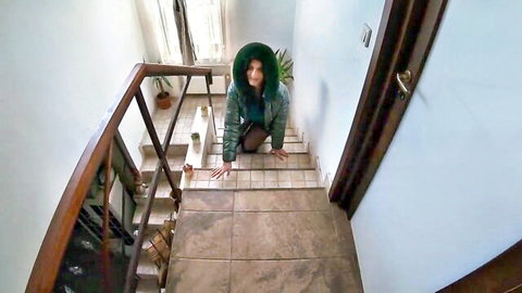 Kneeling mature woman in green shiny down jacket ready for oral and cumshot