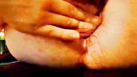 Close-up of tan-skinned woman self-inserting fingers into her big ass, wet and explicit