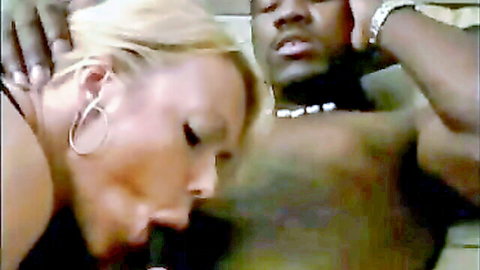 Blonde woman with hoop earrings sucking thick black cock in close-up interracial blowjob
