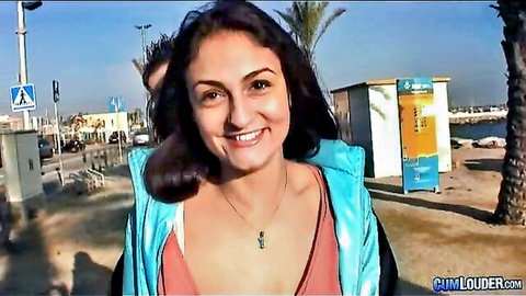 Sandra Milka smiling outdoors in blue jacket with cleavage