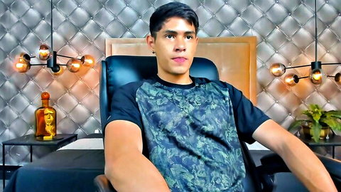 TylerLions Latin cam model in graphic tee, seated and smiling