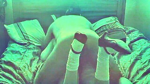 Hawt transvestite with exposed ass, legs in socks and heels on bed