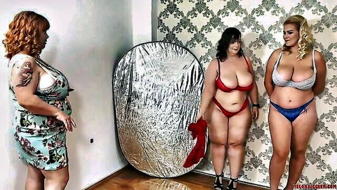 Three curvy busty women in lingerie and dress posing in studio