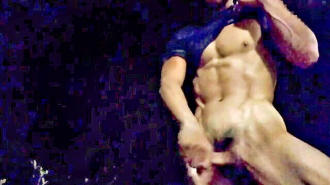 Muscular Asian hunk grips his thick erect cock in solo pose