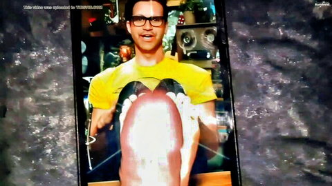 Smiling man in yellow shirt glasses holding open pussy between legs tribute