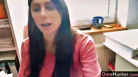 Sexy mature granny in pink top smiling and talking on homemade webcam