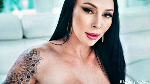 Indica Marie topless with shoulder tattoos, seductive gaze in close-up