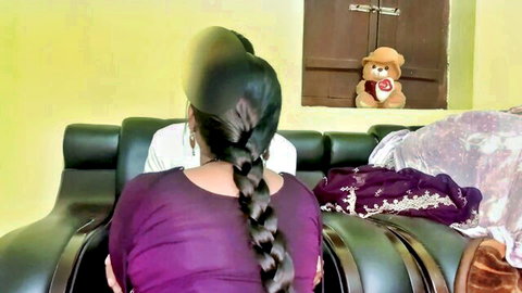 Sexy Indian Bhabhi with long black braid and curvy figure in purple top, teasing from behind
