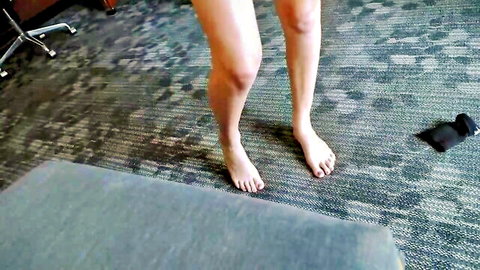 Barefoot woman standing with long legs exposed in short dress