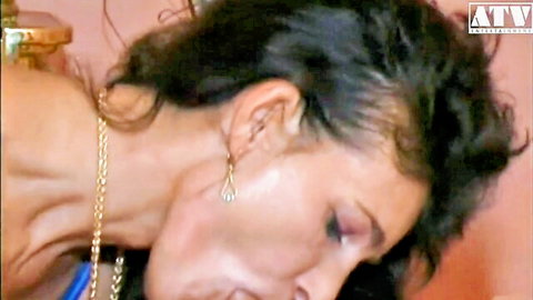 Close-up of mature woman in her 40s with dark hair, aroused expression