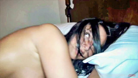 Bianca Ferrero nude on bed, seductive side pose with long hair