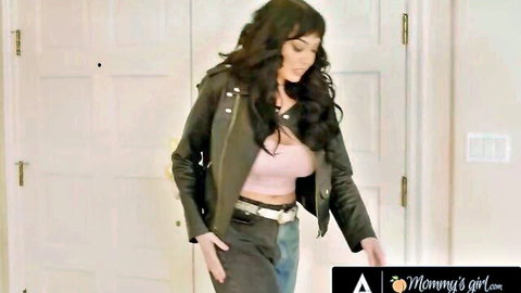 Nicole Kitt in sexy green leather jacket and pink crop top, seductive pose for lesbian threesome