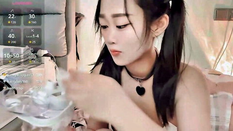 Seductive Asian camgirl Yueyue2003 in pigtails and choker during live stream