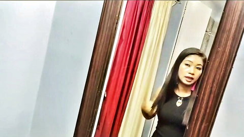 Sexy Indian woman in tight black dress, mirror selfie in hotel room