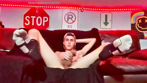 Young guy in sneakers and socks masturbating solo