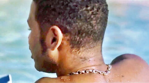 Black male performer shirtless in pool, starring with Penelope Cross