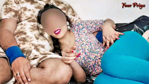 Your Priya in floral dress with partner on bed, intimate Indian couple tease