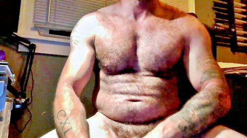 Hairy tattooed bear daddy posing nude with thick cock exposed