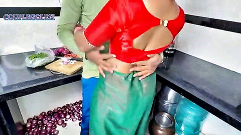 Indian couple in saree and kurta passionately hug from behind in kitchen groping waist