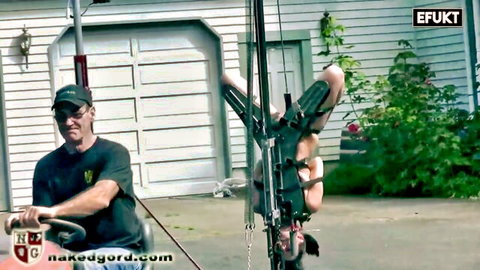 Man drives golf cart with blonde woman bound to sex machine device outdoors