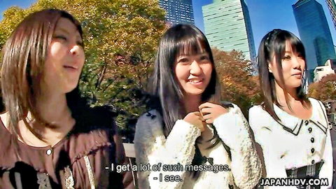 Three smiling Japanese women in sexy autumn dresses outdoors, JAV tease