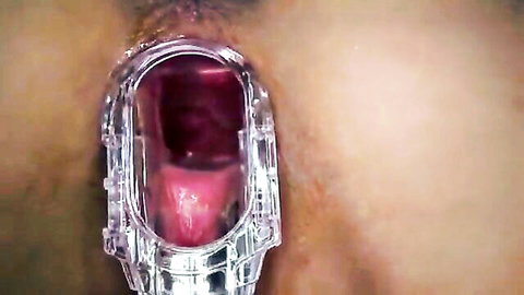 Close-up of tight teen pussy spread wide with speculum, soft outer lips