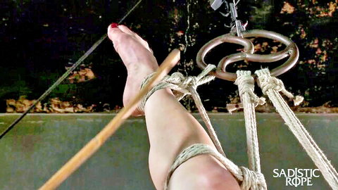 Petite redhead bound in sadistic rope suspension for master's punishment