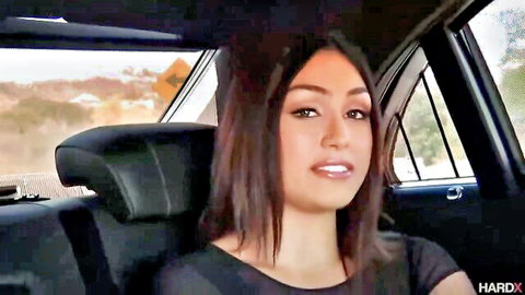 Kylie Sinner smiling seductively in car backseat