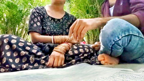 Indian couple in saree and jeans teasing in public park, amateur outdoor