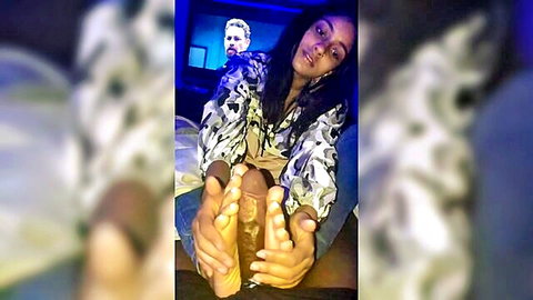 Young ebony amateur gives footjob to hard cock with bare soles and spread toes