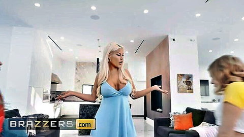 Busty tanned blonde MILF in tight blue dress flaunts huge fake tits to young blonde in yellow top