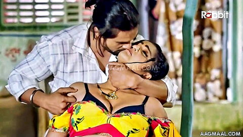 Busty Indian babe's cleavage spills from black bra as hunk kisses her neck passionately