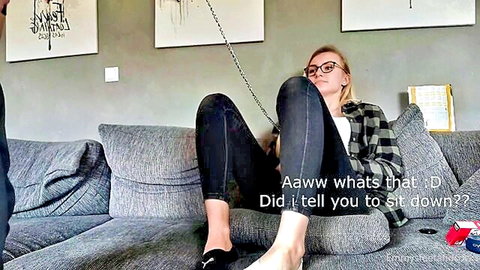Blonde slave woman with leash in foot fetish worship scene