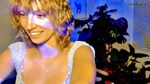 Smiling blonde woman in off-shoulder dotted top with cleavage