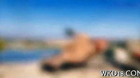 Blurry nude MILFs with big asses bending over on sunny beach teasing