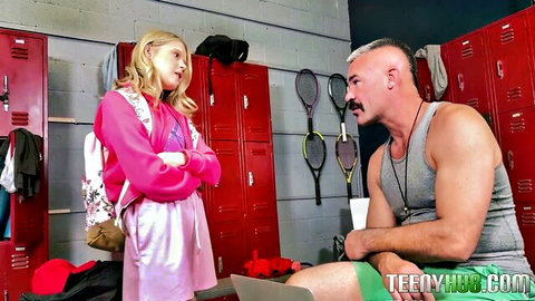 Blonde teen schoolgirl confronts muscular bald coach in pink outfit, locker room discipline tease