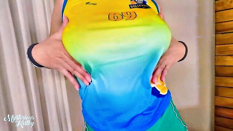 MysteriousKathy teasing in tight yellow volleyball jersey, big breasts emphasized