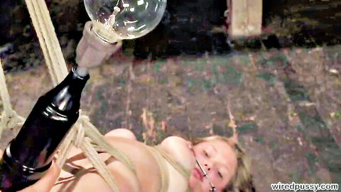 Sara Scott bound in ropes, suspended naked by Sandra Romain in BDSM scene