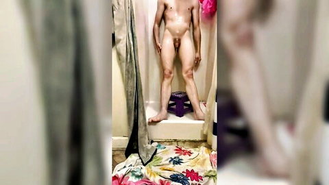 Athletic young Caucasian guy standing nude in shower exposing soft cock and balls full frontal