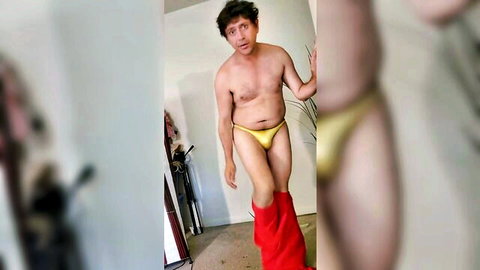 Hairy man in yellow bulge underwear, red pants down, seductive pose