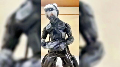 Man in tight black rubber fetish suit with white hair and goggles
