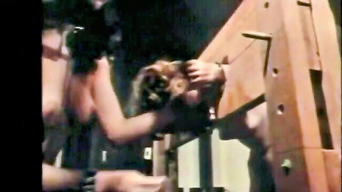 Lesbian BDSM: bound brunette woman whipped by dominant partner