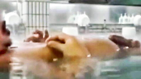 Steamy Japanese sauna with nude Asian woman touching breasts in water